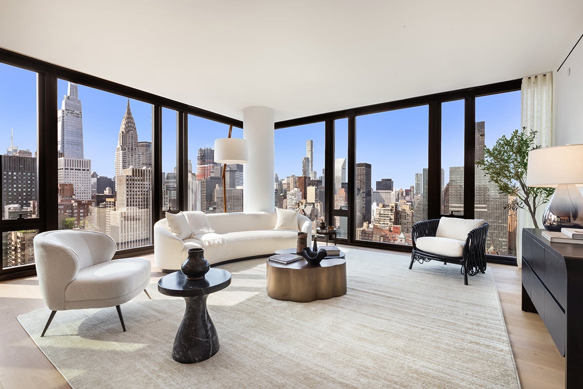 Luxurious modern penthouse living room with floor-to-ceiling windows and contemporary furnishings in NYC
