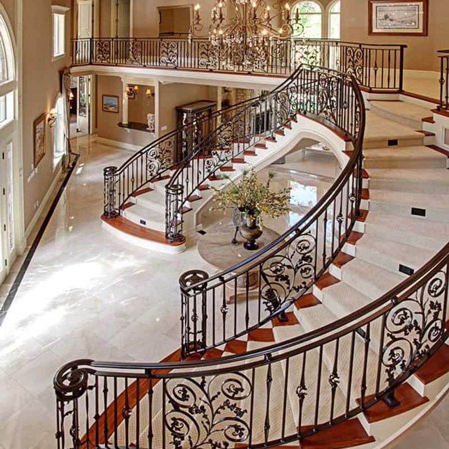 Grand entrance of a luxurious mansion with opulent architectural details